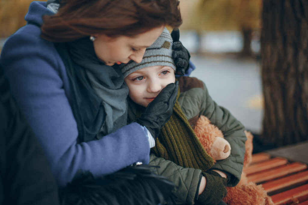 Realistic illustration of a concerned parent comforting a child with mood swings, symbolizing DMDD and emotional support